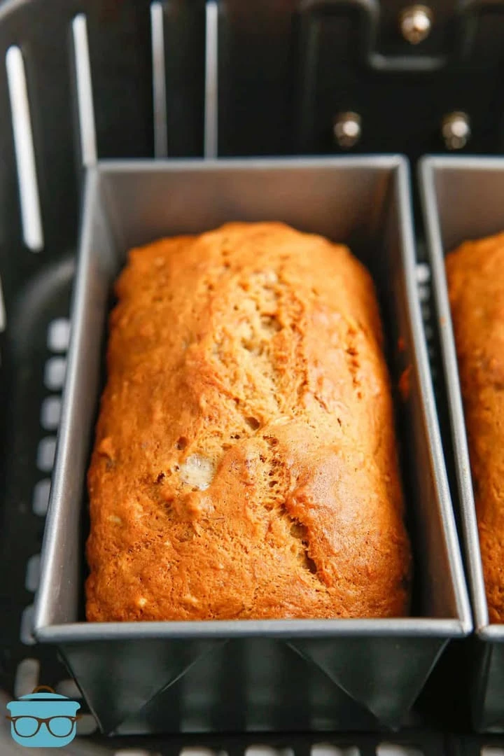 Slice of moist air fryer banana bread on a wooden cutting board