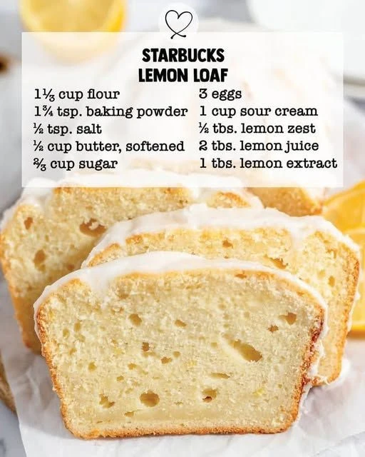 Sliced easy lemon loaf with a glaze on a wooden table