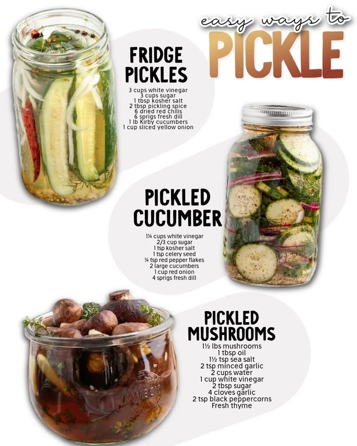 Homemade pickles in jars with fresh vegetables and spices.