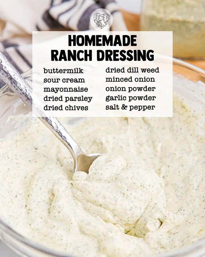 A bowl of homemade ranch dressing with fresh herbs and ingredients.