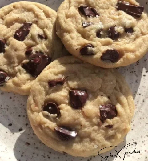 Freshly baked chocolate chip cookies on a cooling rack