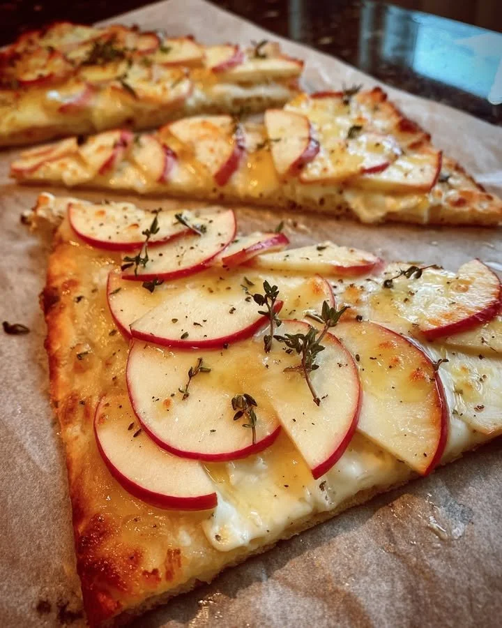 Apple Brie Flatbread drizzled with Honey-Thyme Glaze on a rustic wood board