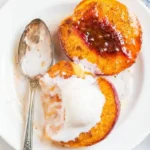 Delicious baked peaches served with a sprinkle of cinnamon and vanilla ice cream