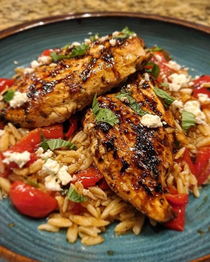 Balsamic Glazed Chicken served with orzo, goat cheese, and roasted red peppers