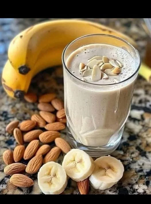 Delicious Banana Almond Smoothie in a glass with almonds and banana slices