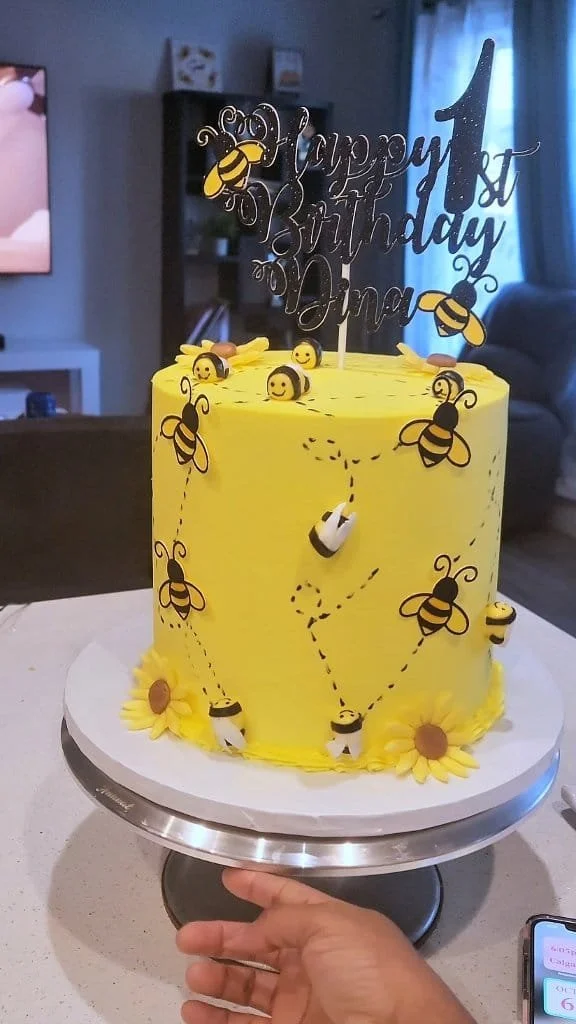 Bee-themed birthday cake for a 1st birthday celebration