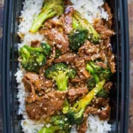 Plate of beef and broccoli stir-fry with rice in a colorful presentation