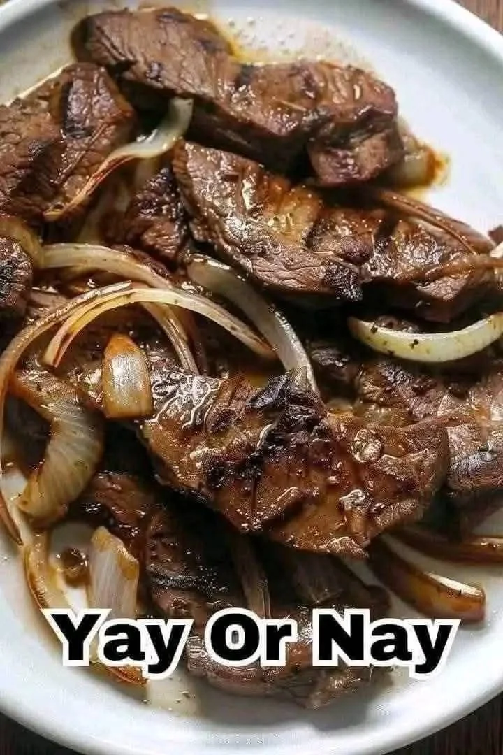 Sautéed beef liver and onions served on a plate.