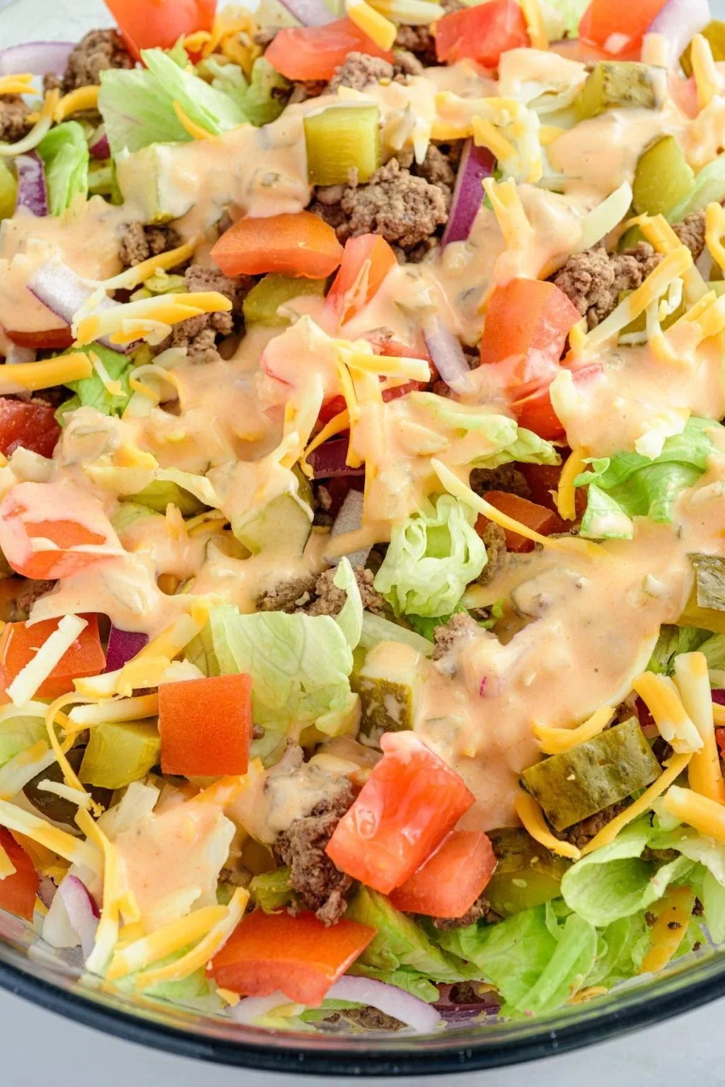 Big Mac Salad with fresh ingredients and special sauce served in a bowl
