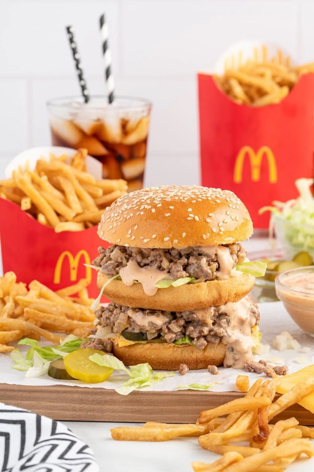 Big Mac Sloppy Joes on a plate with toppings and ingredients nearby