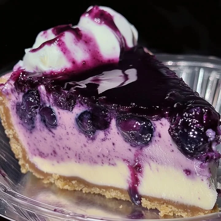 Delicious slice of blueberry cheesecake with fresh blueberries on top