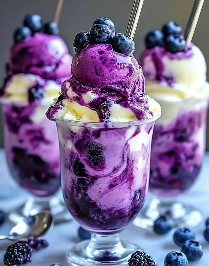 Blueberry and vanilla swirl ice cream parfait in a clear dessert cup