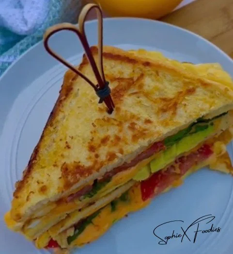 Delicious breakfast sandwich with eggs, cheese, and bacon on toasted bread.
