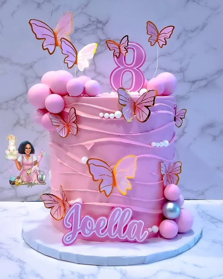 Colorful butterfly theme cake decorated with edible flowers and whimsical design