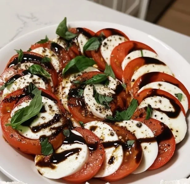 Fresh Caprese Salad with tomatoes, mozzarella, and basil on a rustic plate