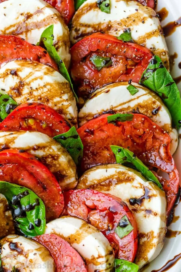 Delicious Caprese Salad with fresh tomatoes, mozzarella cheese, and basil leaves.