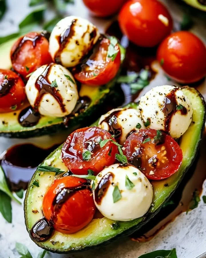 Delicious Caprese Stuffed Avocado with tomatoes, mozzarella, and basil