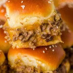 Delicious cheeseburger sliders served on a platter with toppings and sauces.