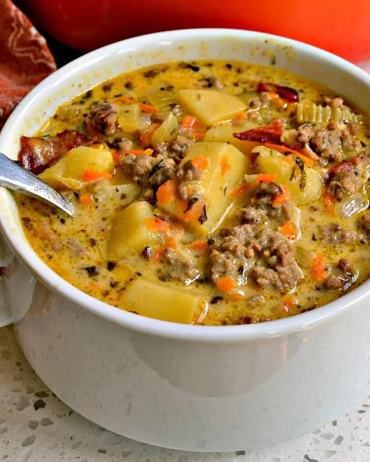 Delicious bowl of homemade Cheeseburger Soup garnished with cheese and green onions.