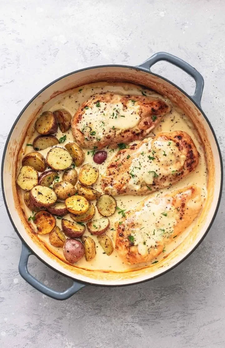 Plate of Chicken and Potatoes in Creamy Dijon Sauce garnished with fresh herbs