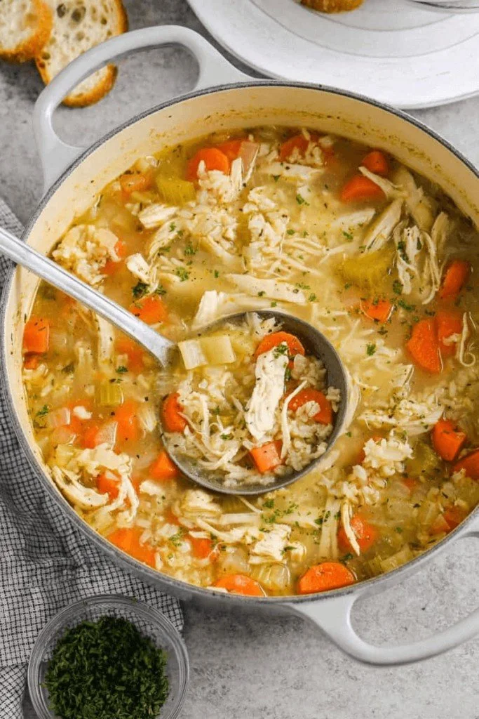 Bowl of delicious Chicken and Rice Soup garnished with herbs