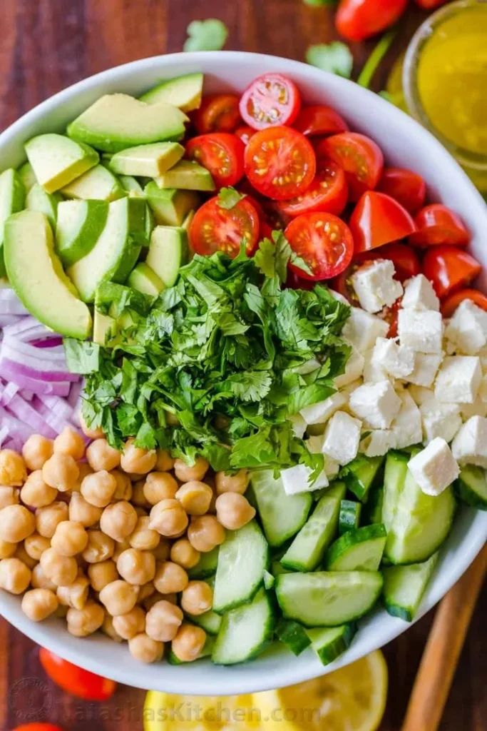 Delicious and colorful chickpea salad with fresh vegetables and dressing