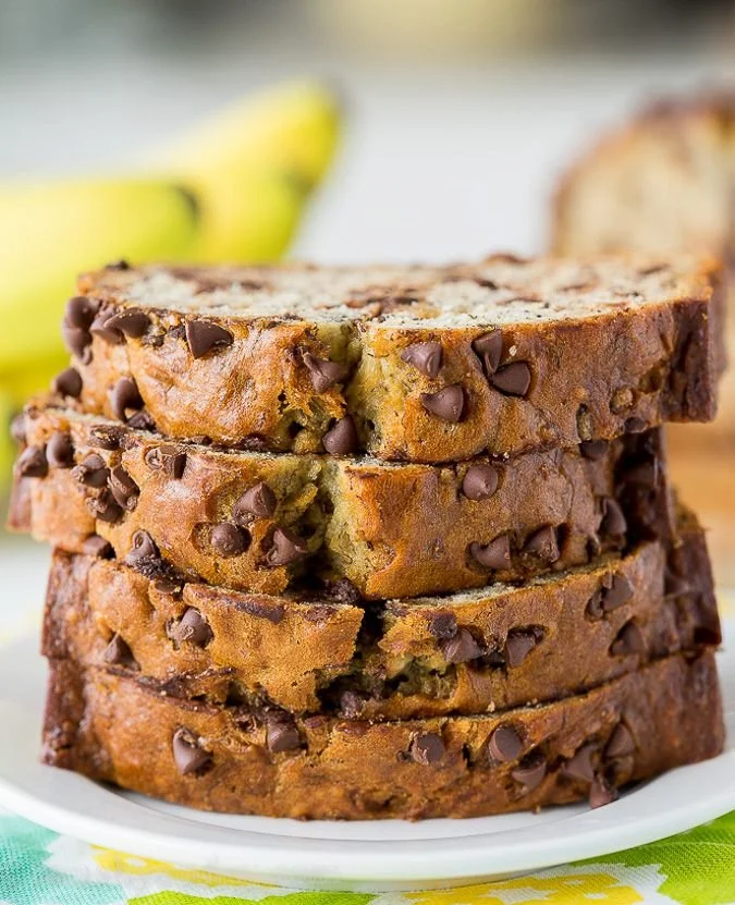 Loaf of chocolate chip banana bread baked to perfection with chocolate chunks on top