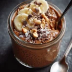 Chocolate peanut butter chia pudding topped with cacao nibs and peanuts