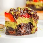 Chocolate strawberry pistachio fudge bars on a white plate