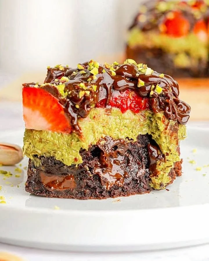 Chocolate strawberry pistachio fudge bars on a white plate