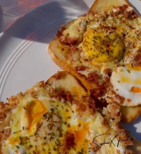 Chorizo eggs on toast with melted cheese, a delicious breakfast dish.