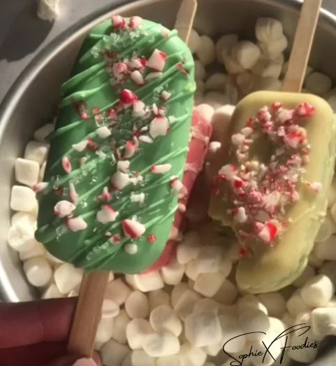 Festively decorated Christmas Cakesicles ready for holiday celebrations