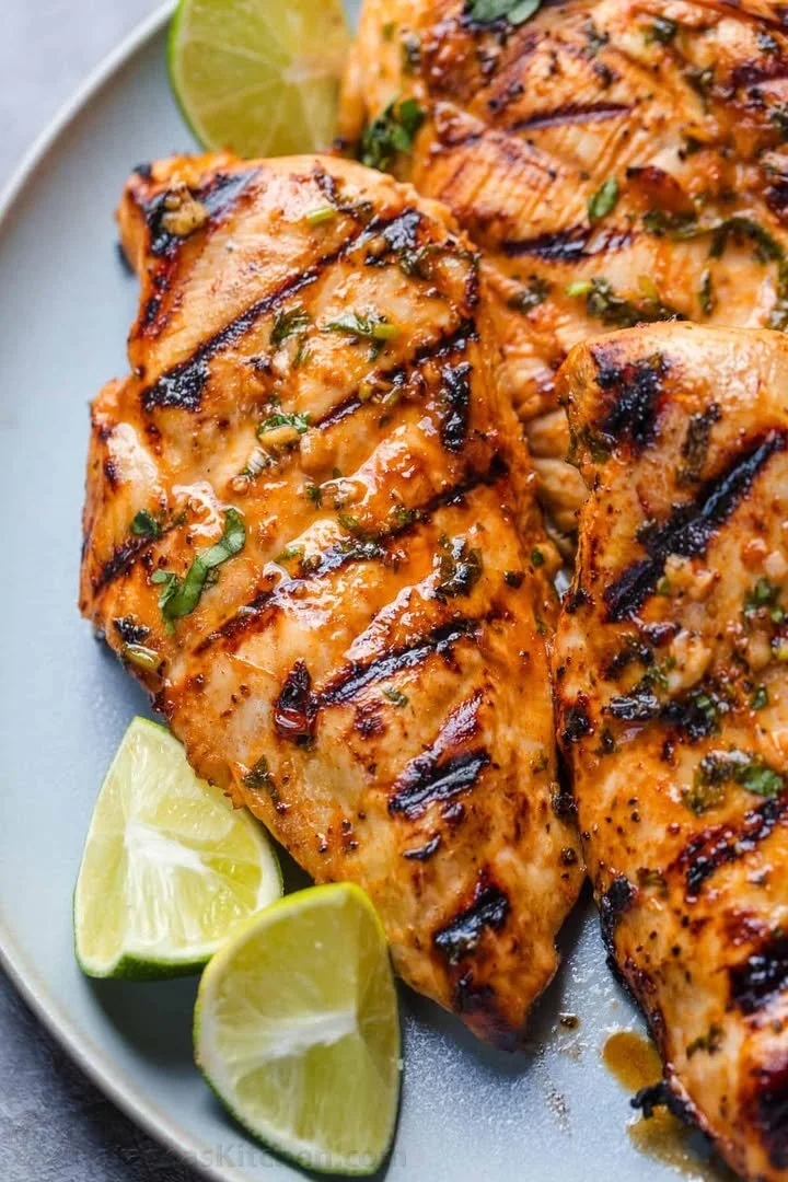 Delicious cilantro lime chicken garnished with fresh cilantro and lime wedges.