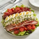 Delicious classic Cobb Salad with chicken, bacon, avocado, and eggs