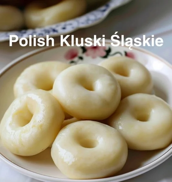 Plate of classic Silesian Dumplings served with sauce and herbs