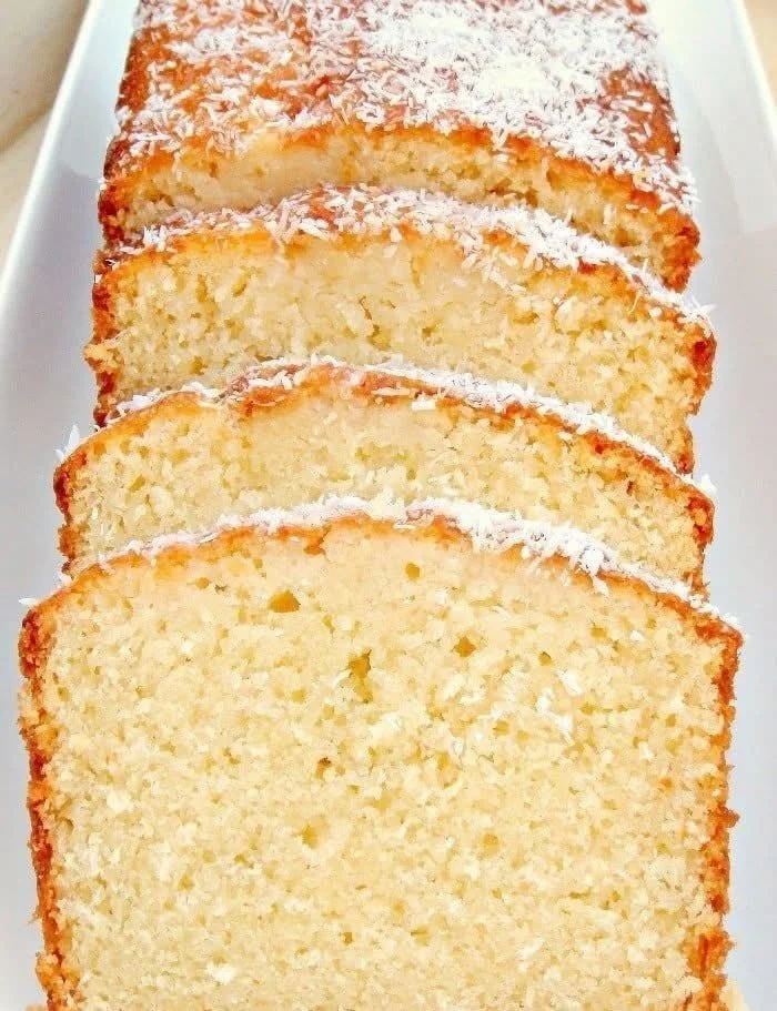 Delicious slice of Coconut Pound Cake garnished with coconut flakes