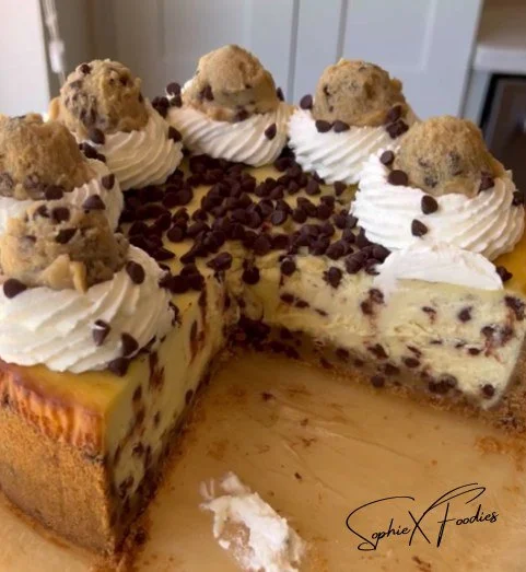 Delicious Cookie Dough Cheesecake topped with cookie dough bites and chocolate drizzle
