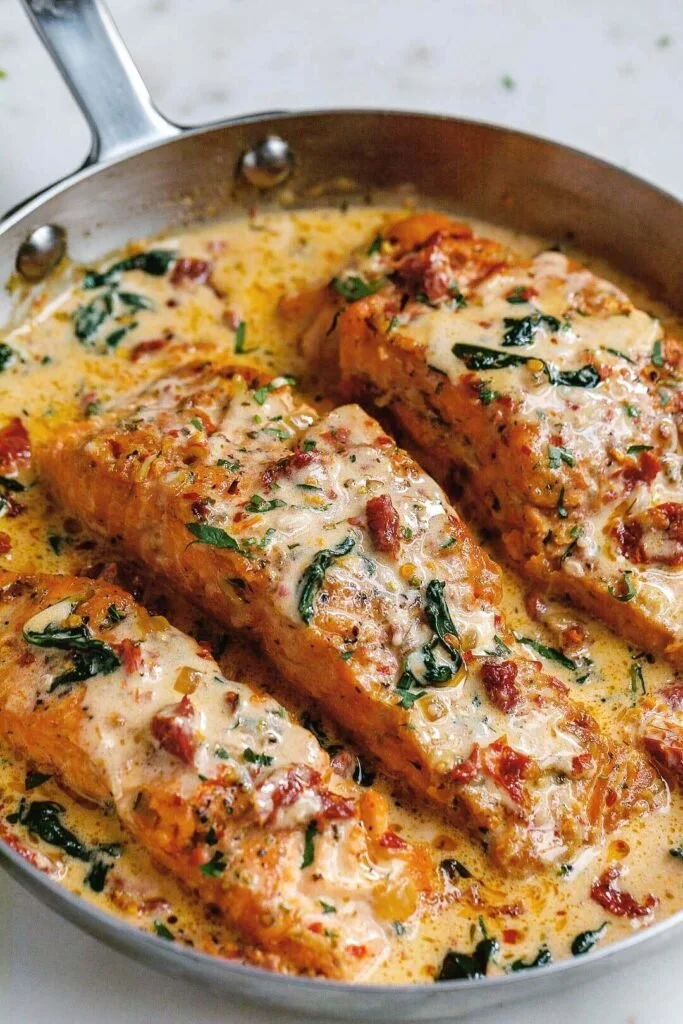 Creamy Garlic Tuscan Salmon garnished with spinach and sun-dried tomatoes