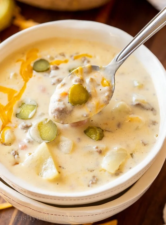 Delicious creamy soup in a bowl garnished with herbs