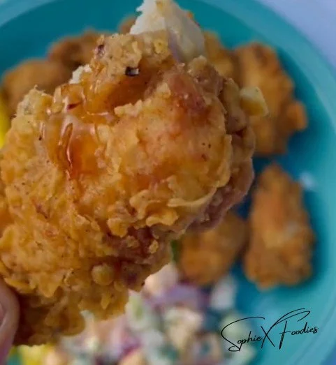 Plate of Crispy Crunch Wings, golden brown and crispy, garnished with fresh herbs.