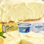 A delicious slice of no-bake Lemonade Pie on a decorative plate, garnished with lemon slices.