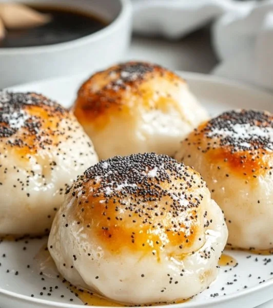 Dumplings with poppy seed sugar and vanilla sauce, a delightful dessert dish.