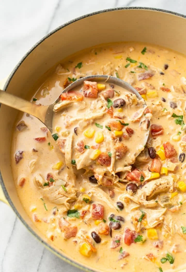 Bowl of easy chicken taco soup topped with cheese and cilantro