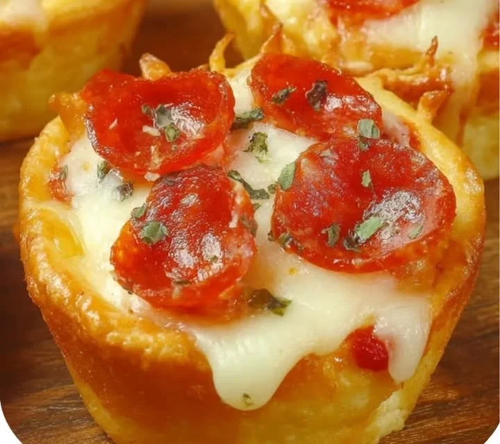 Delicious easy pizza cupcakes topped with cheese and pepperoni.