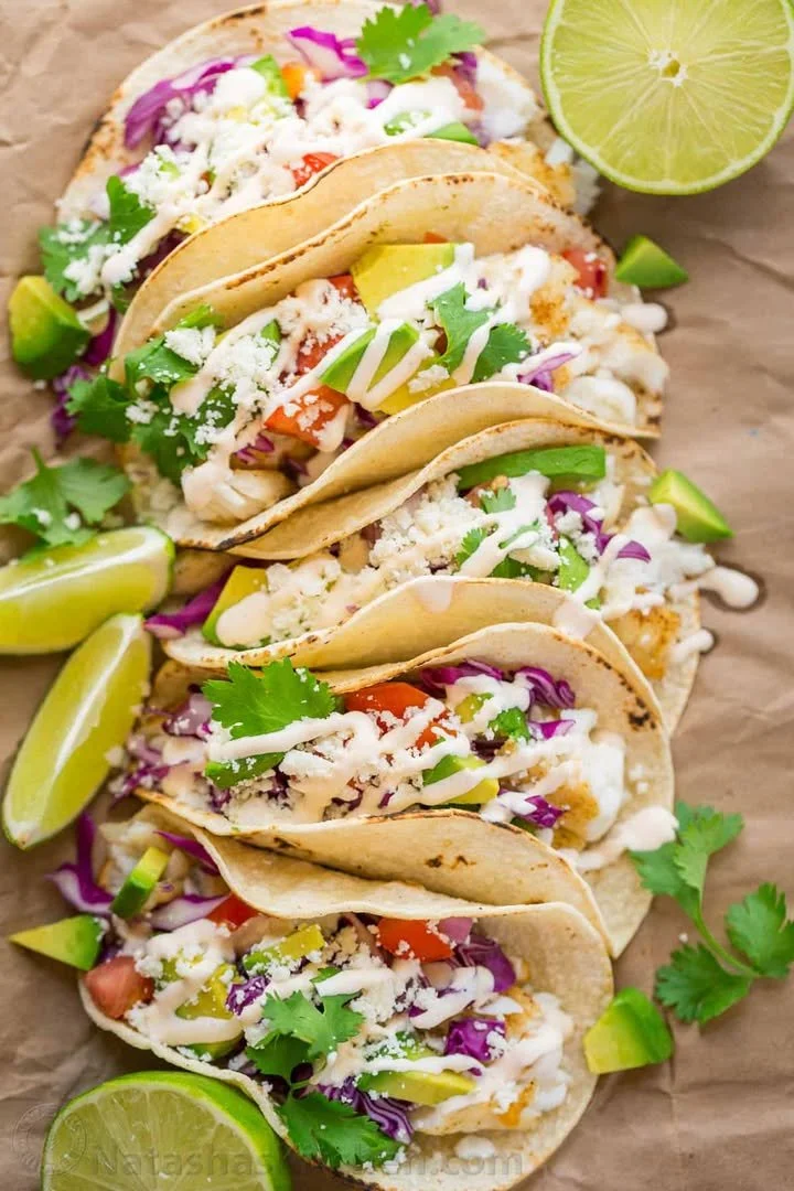 Delicious homemade fish taco garnished with fresh vegetables and salsa
