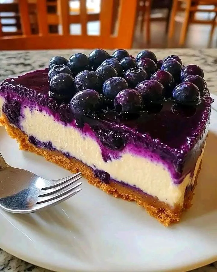 Delicious Fresh Blueberry Cheesecake garnished with blueberries on top