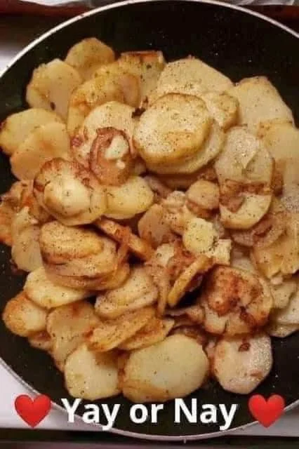 Plate of fried potatoes and onions served with smoked sausage