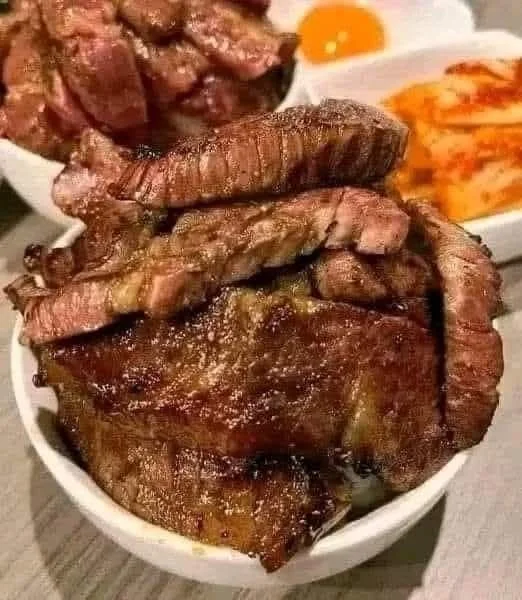 Juicy Garlic Herb Butter Steak on a plate garnished with herbs