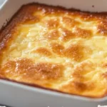 Slice of German Butter Cake on a plate with a cup of tea