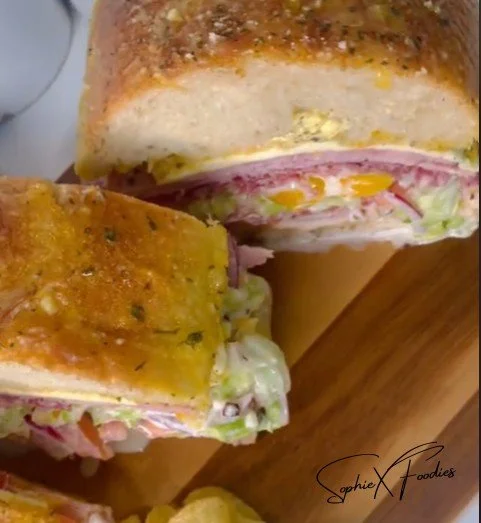 Delicious Grinder Sandwich loaded with meats and fresh veggies on a toasted roll.